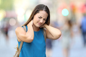 Photo of lady holding her aching neck